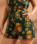 Woman wearing tropical tiki print pull-on shorts with elastic waistband and side pockets.