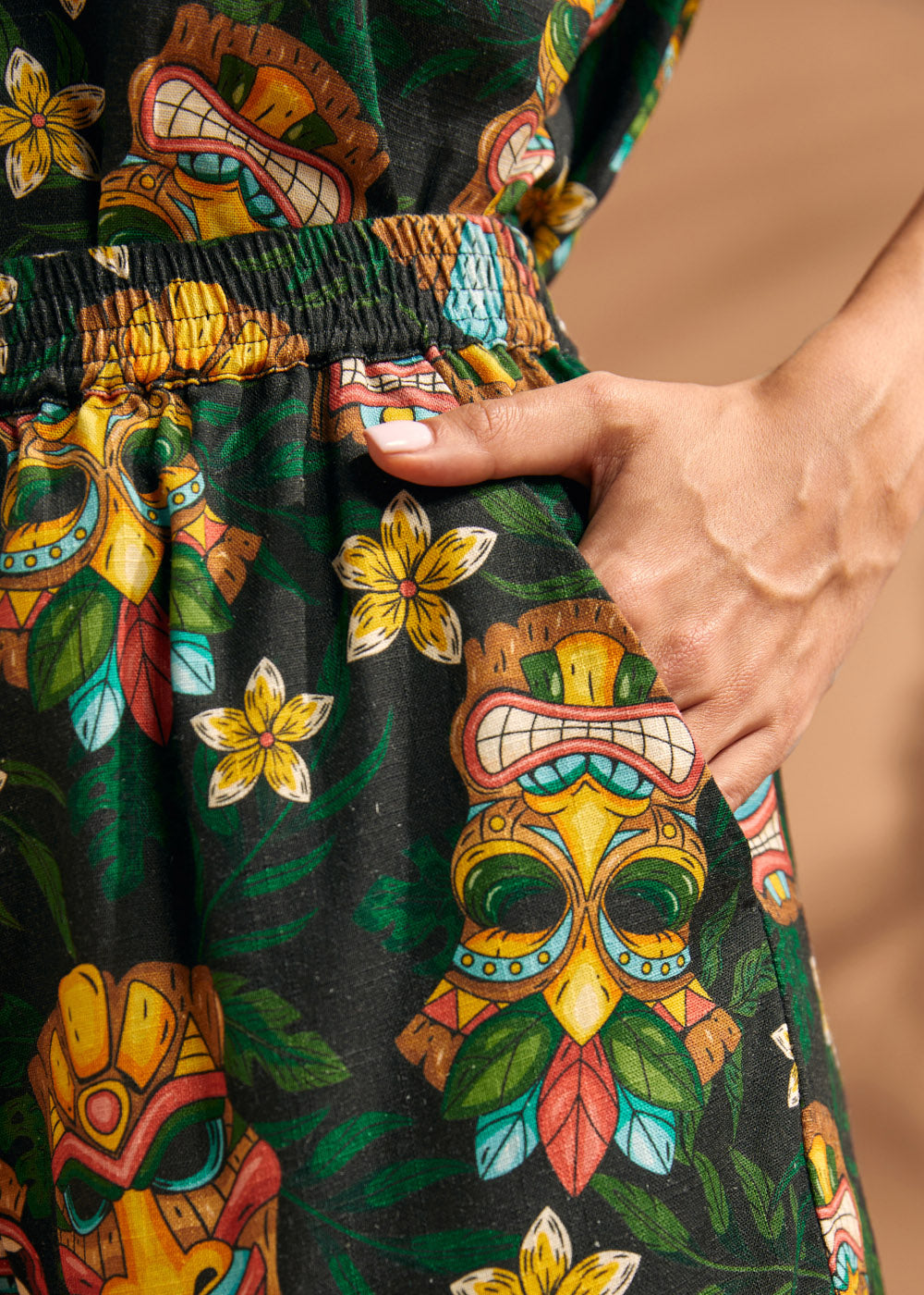 Close-up of side pocket on tropical tiki print linen blend shorts.