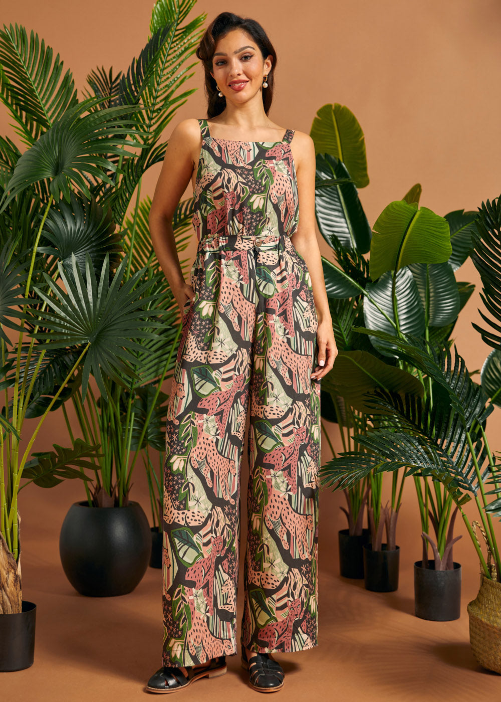 Woman wearing jungle cat print wide-leg palazzo pants with a matching sleeveless top.