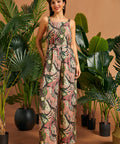 Woman wearing jungle cat print wide-leg palazzo pants with a matching sleeveless top.