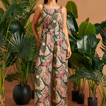 Woman wearing jungle cat print wide-leg palazzo pants with a matching sleeveless top.