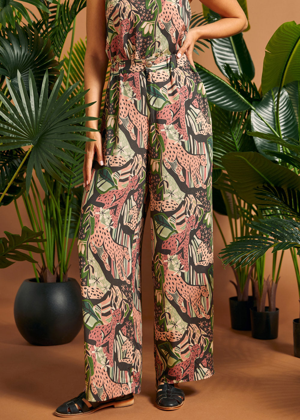 Side view of lightweight jungle print palazzo pants with flowing legs.