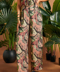 Side view of lightweight jungle print palazzo pants with flowing legs.