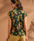 Back view of tropical novelty print blouse with back yoke and center pleat.