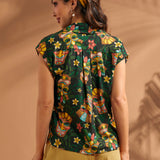 Back view of tropical novelty print blouse with back yoke and center pleat.