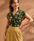 Front view of women's tropical tiki print button-up blouse with relaxed fit.