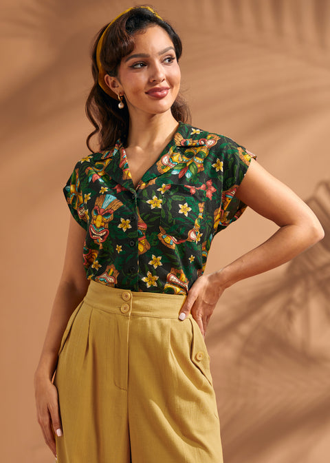 Front view of women's tropical tiki print button-up blouse with relaxed fit.