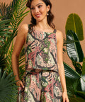 Woman wearing a sleeveless novelty print cami with wide straps.