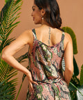 Side-back view of the jungle print shell top with decorative buttons.