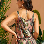 Side-back view of the jungle print shell top with decorative buttons.