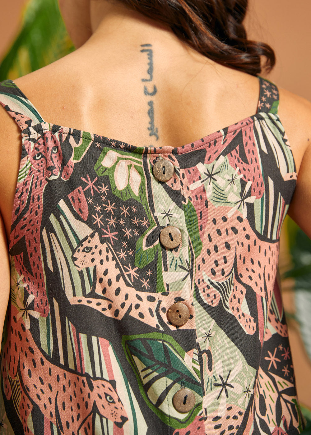 Back view of the cropped tank featuring coconut button detailing.