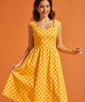 Front view of yellow cotton dress featuring a vintage-inspired silhouette and side pockets.