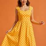 Front view of yellow cotton dress featuring a vintage-inspired silhouette and side pockets.