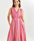 Woman wearing a pink striped summer dress on a white background