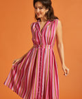 Woman modeling multicolored striped rayon blend midi dress with side pockets.