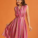 Woman modeling multicolored striped rayon blend midi dress with side pockets.