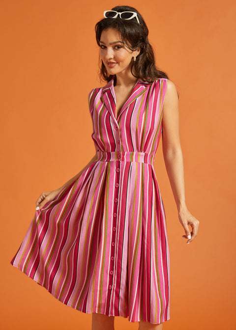 Woman modeling multicolored striped rayon blend midi dress with side pockets.