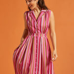 Woman wearing colorful striped sleeveless dress with full skirt and side pockets.
