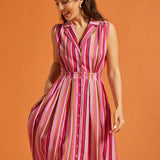 Woman wearing colorful striped sleeveless dress with full skirt and side pockets.