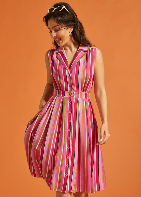 Woman wearing colorful striped sleeveless dress with full skirt and side pockets.