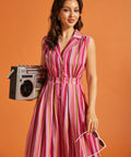 Woman wearing a vintage-inspired striped fit and flare midi dress with functional buttons.