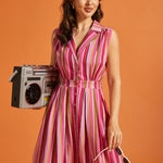 Woman wearing a vintage-inspired striped fit and flare midi dress with functional buttons.