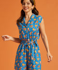 Woman wearing a playful roller rink inspired romper with vintage roller skate print.