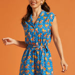 Woman wearing a playful roller rink inspired romper with vintage roller skate print.