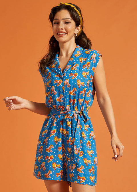 Woman wearing a playful roller rink inspired romper with vintage roller skate print.