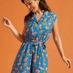 Woman wearing a retro-inspired viscose romper with roller skate print and side pockets.