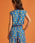 Back view of a lightweight blue printed romper with an elastic waist.