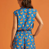 Back view of a lightweight blue printed romper with an elastic waist.