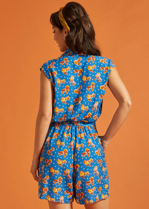 Back view of a lightweight blue printed romper with an elastic waist.