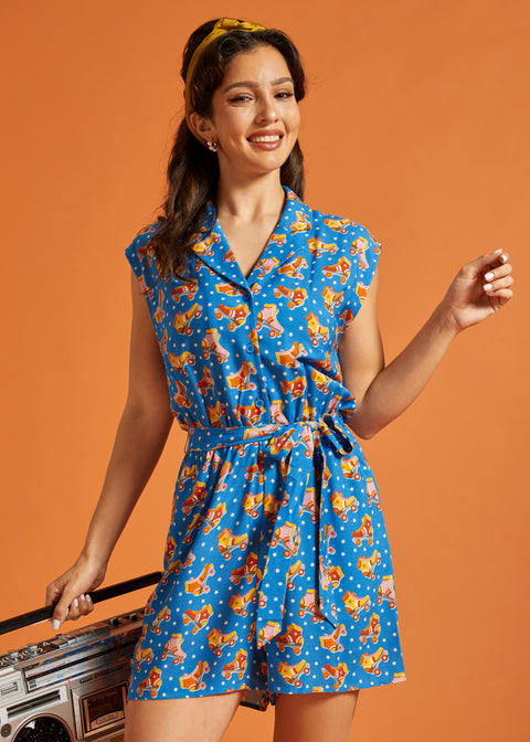 Front view of a blue novelty print romper with an adjustable tie belt.
