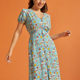 Woman wearing whimsical skull and floral print midi dress with tie waist.