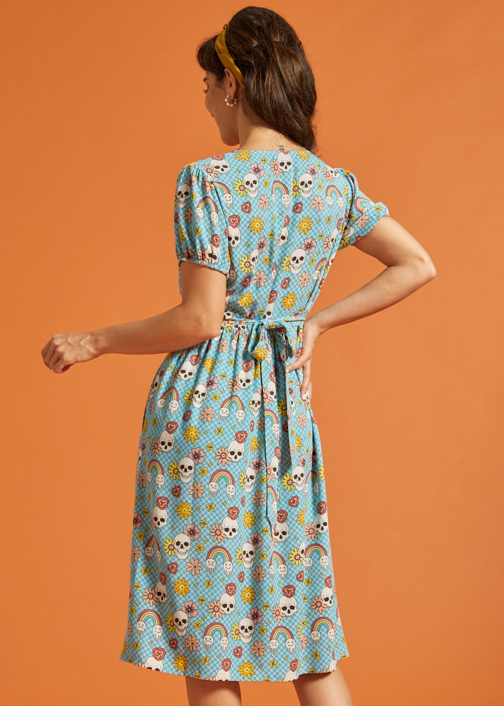 Back view of blue button-front midi dress with attached waist tie and puff sleeves.