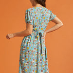 Back view of blue button-front midi dress with attached waist tie and puff sleeves.