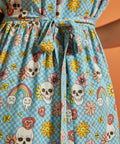 Close-up of attached self-tie waist on blue novelty skull and floral print dress.