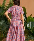 Back view of vintage-inspired midi dress with elastic back waist and full skirt.