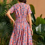 Back view of vintage-inspired midi dress with elastic back waist and full skirt.