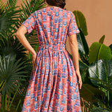 Back view of vintage-inspired midi dress with elastic back waist and full skirt.
