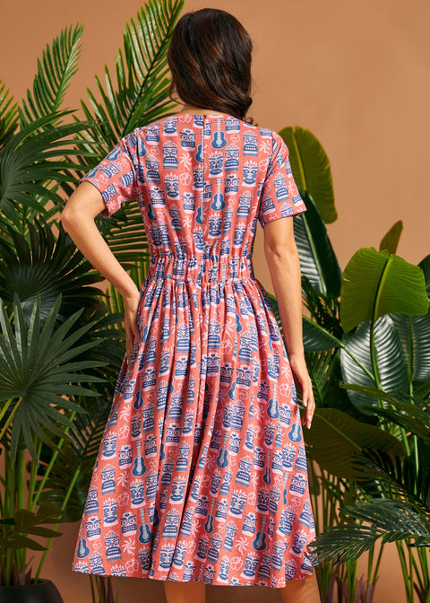 Back view of vintage-inspired midi dress with elastic back waist and full skirt.