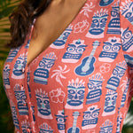 Close-up of V-neck button-front bodice featuring tiki mask and ukulele print.