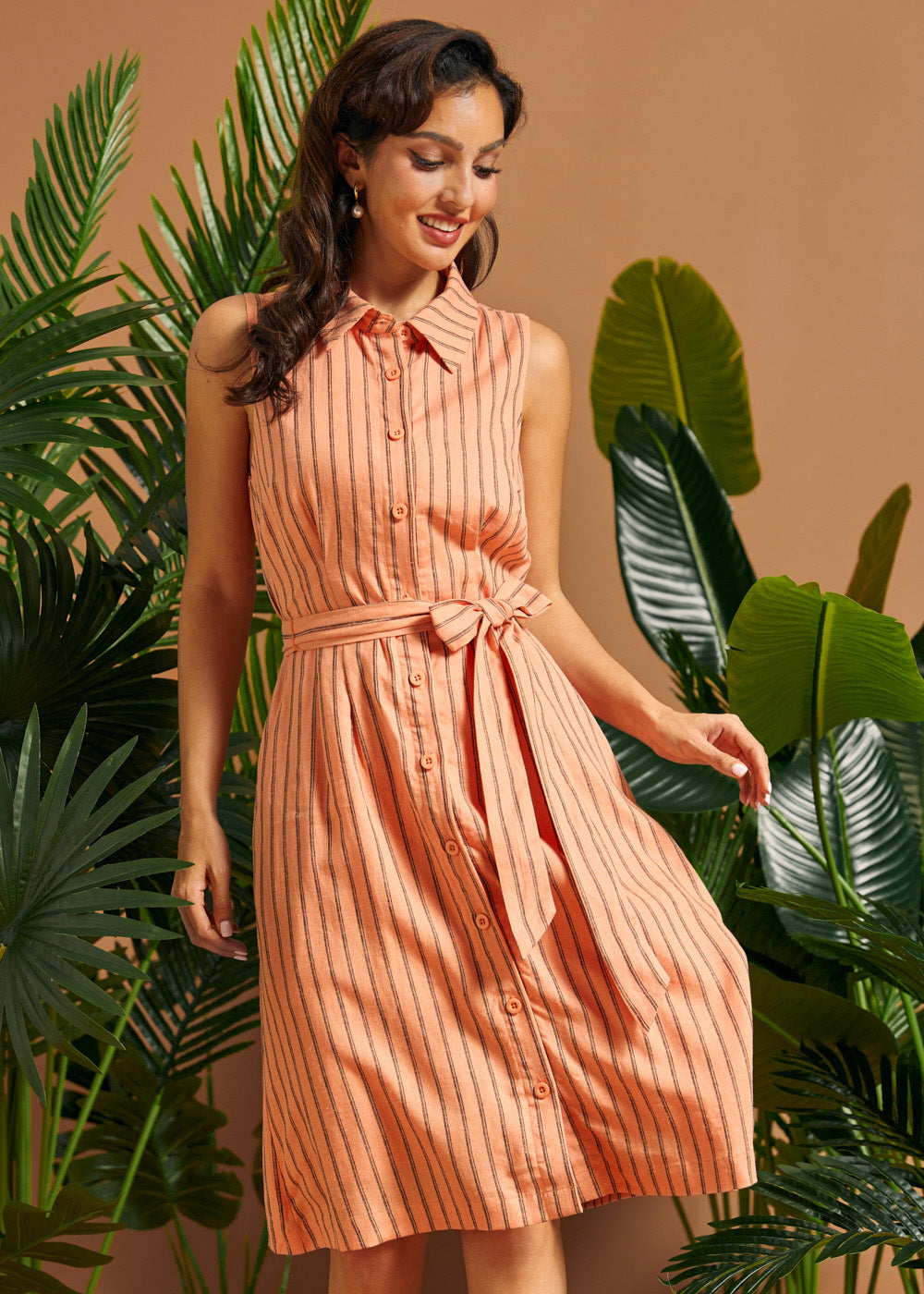 Front view of a sleeveless linen blend button-front dress with vertical stripes.