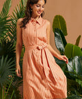 Front view of a sleeveless linen blend button-front dress with vertical stripes.