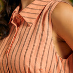 Close-up of the pointed collar and woven pinstripe fabric on a sleeveless shirt dress.