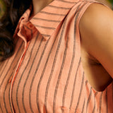 Close-up of the pointed collar and woven pinstripe fabric on a sleeveless shirt dress.