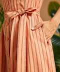 Close-up of the adjustable self-tie waist sash and side pocket.