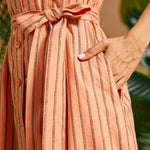 Close-up of the adjustable self-tie waist sash and side pocket.