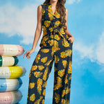 Woman wearing tropical leaf print tie-front shirt with matching wide-leg pants
